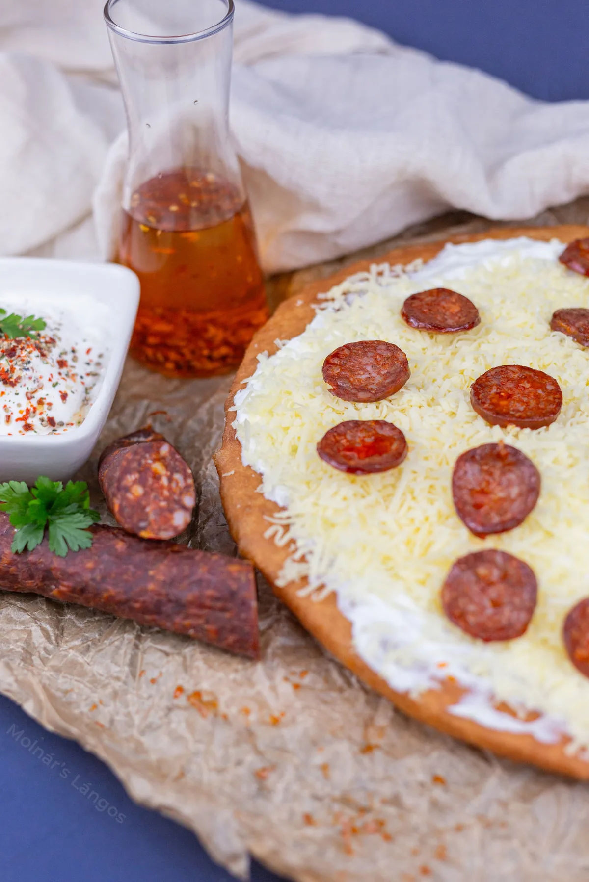 Sour cream and cheese lángos with Hungarian sausage