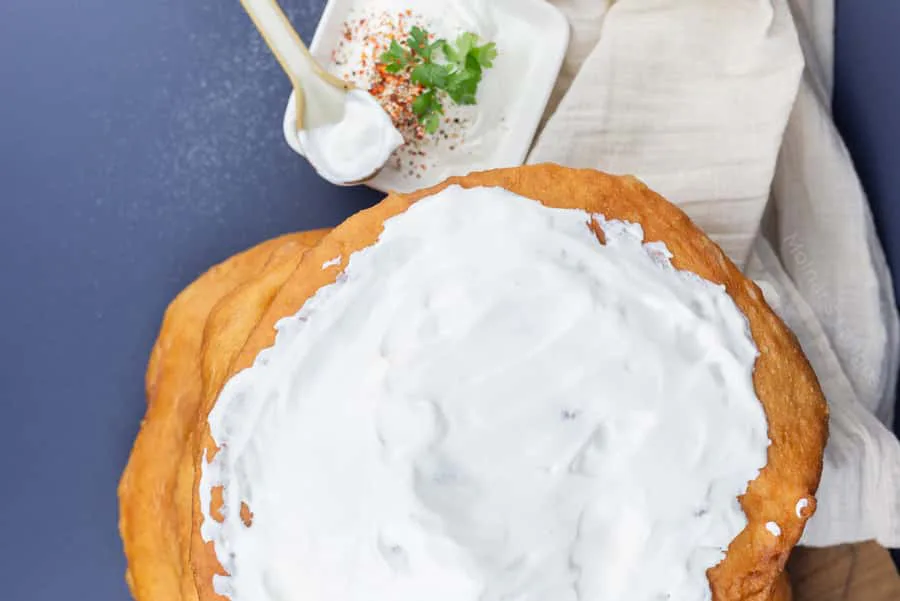 Freshly served lángos with sour cream